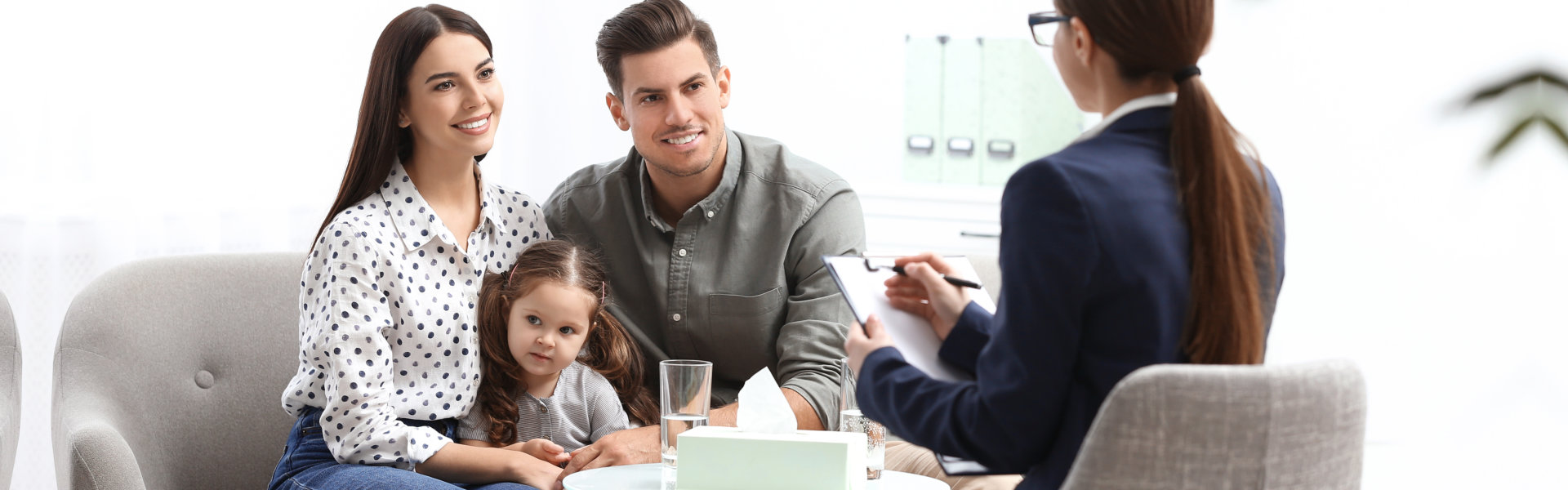 family sitting together and looking at the woman