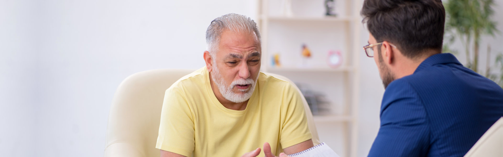 elderly talking to his therapist