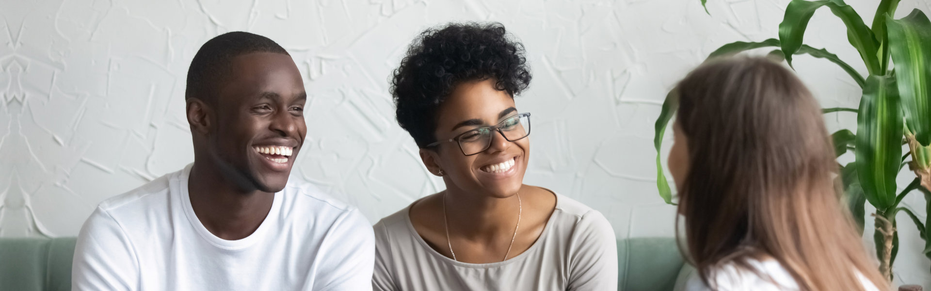 couple smiling and looking at the woman