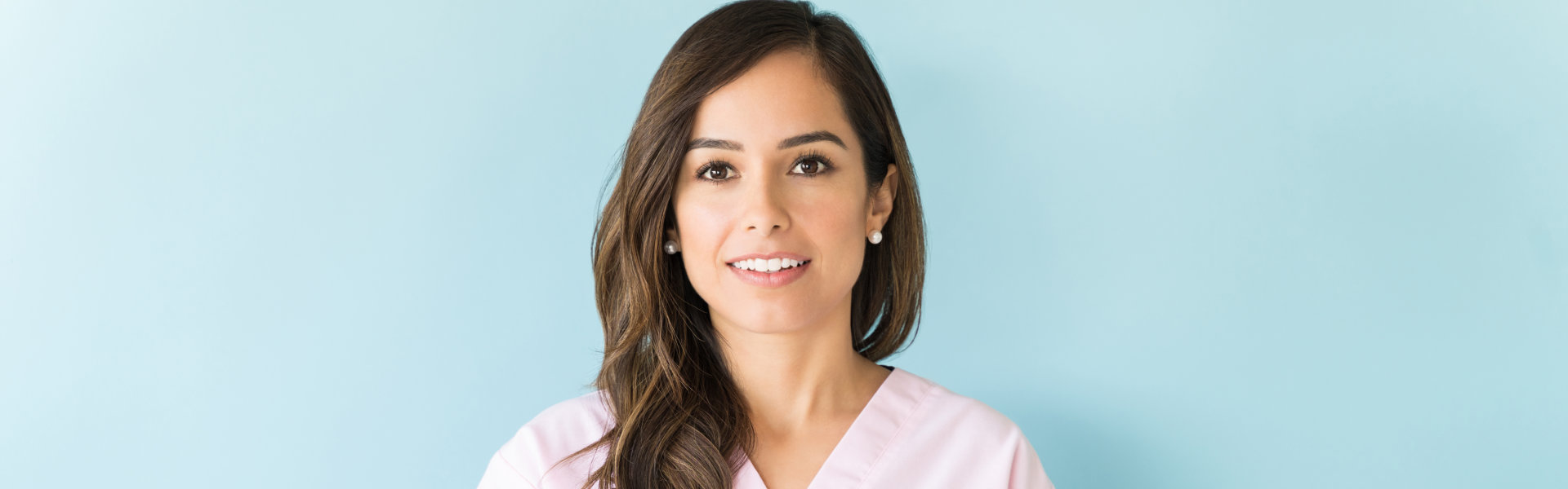 woman smiling with a light blue background